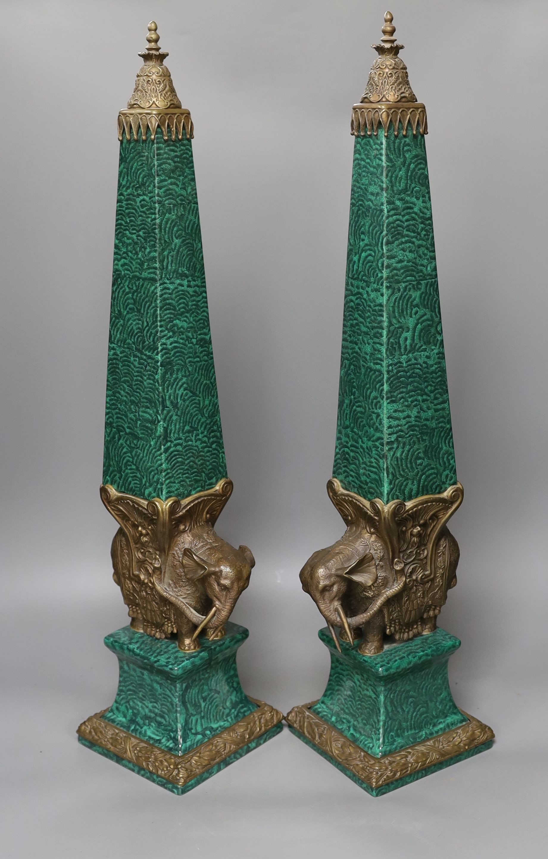 A decorative pair of faux malachite ‘elephant’ obelisks 65cm tall